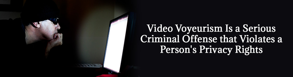 Man Engaging in Video Voyeurism While Looking at Laptop Screen