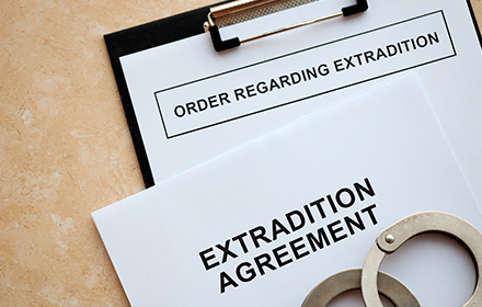 Handcuffs on Top of Extradition Agreement Document During a Legal Process