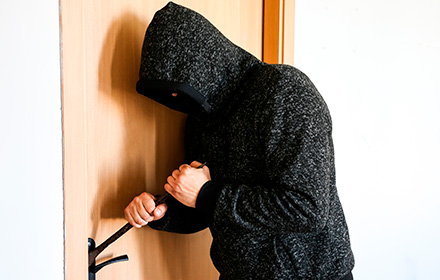 Shot of a Criminal Trying to Break into a Home and Risking Burglary Charges